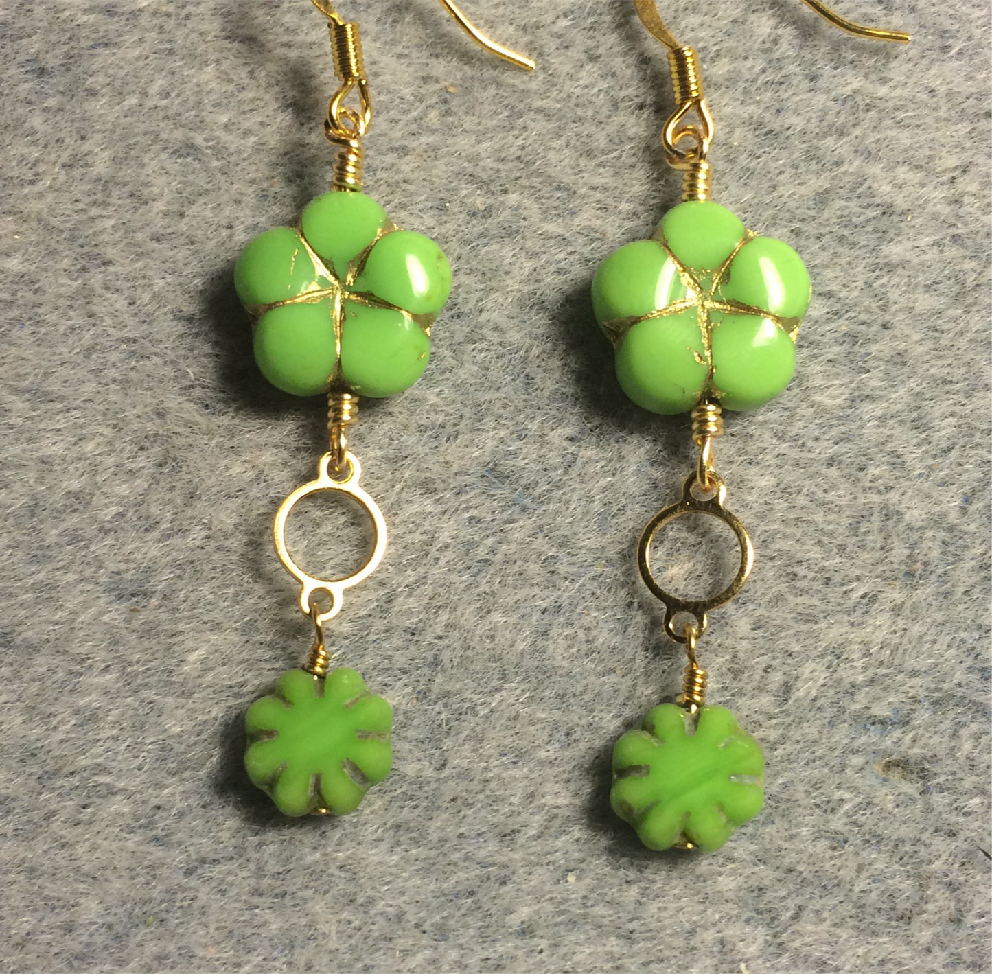 Lime green Czech glass puffy flower bead earrings adorned with gold circle connectors and small lime green Czech glass daisy beads.