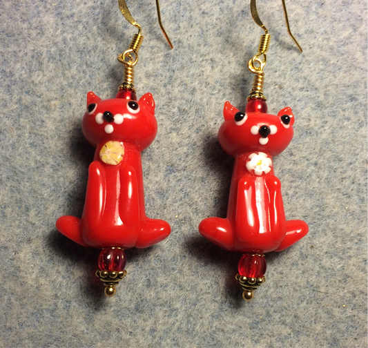 Opaque red lamp work cat bead earrings adorned with red Czech glass beads.