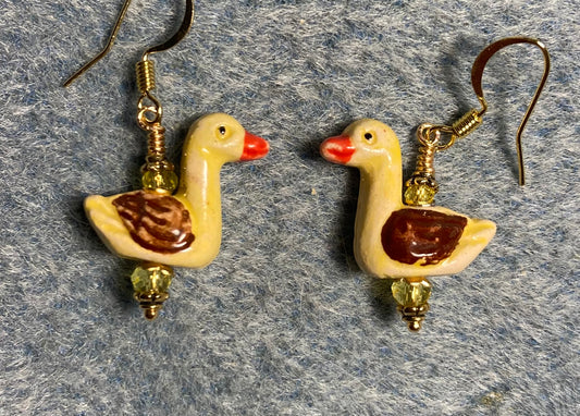 Small yellow, brown, and red ceramic duck bead earrings adorned with yellow Chinese crystal beads.