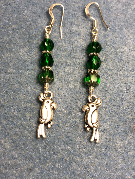 Silver parrot charm earrings adorned with emerald green Czech glass beads