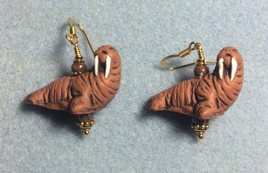 Brown ceramic walrus bead earrings adorned with brown Czech glass beads.