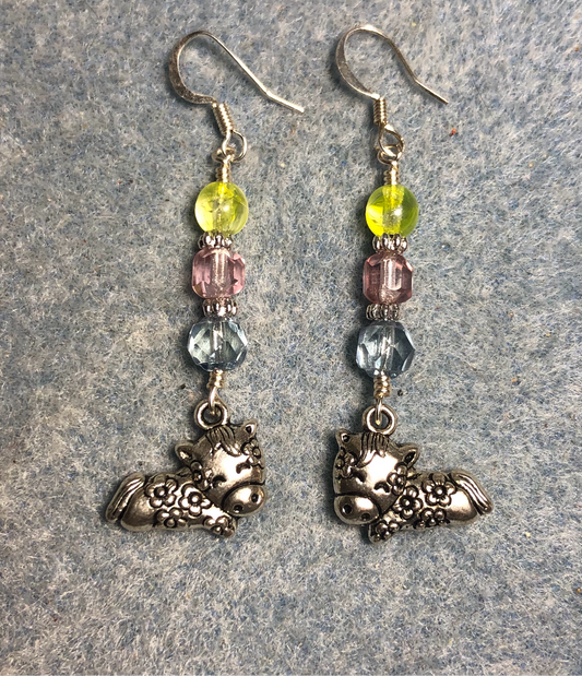 Silver sleeping cow charm earrings adorned with light blue, light pink, and lemon yellow Czech glass beads.