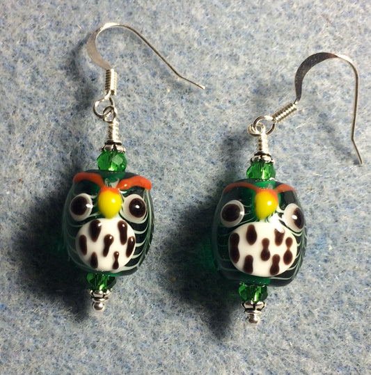 Emerald green and white lamp work spotted owl bead earrings adorned with green Chinese crystal beads.