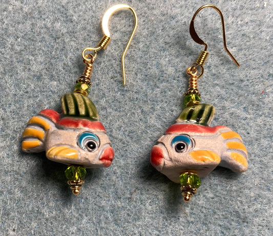 Small beige, yellow, red, and green ceramic fish bead earrings adorned with olive green Chinese crystal beads.