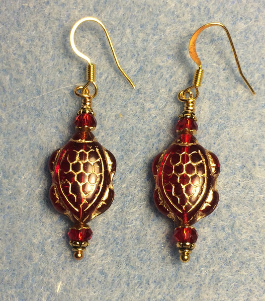 Bright red (with gold inlay) Czech glass turtle bead earrings adorned with red Chinese crystal beads.