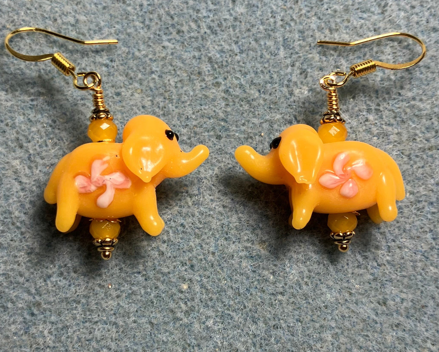 Yellow amber lamp work elephant bead earrings adorned with yellow Chinese crystal beads.