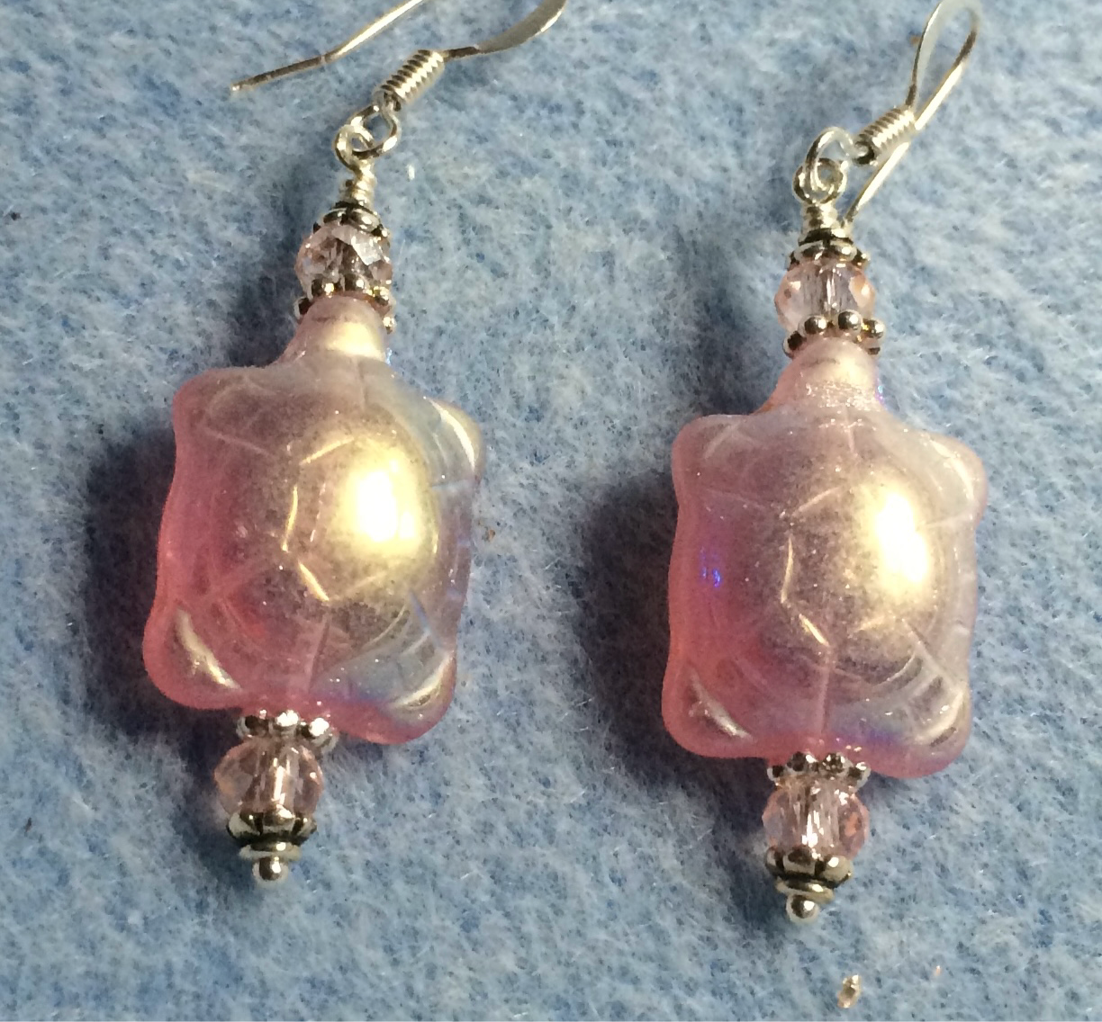 Iridescent pink Czech glass turtle bead earrings adorned with pink Chinese crystal beads.