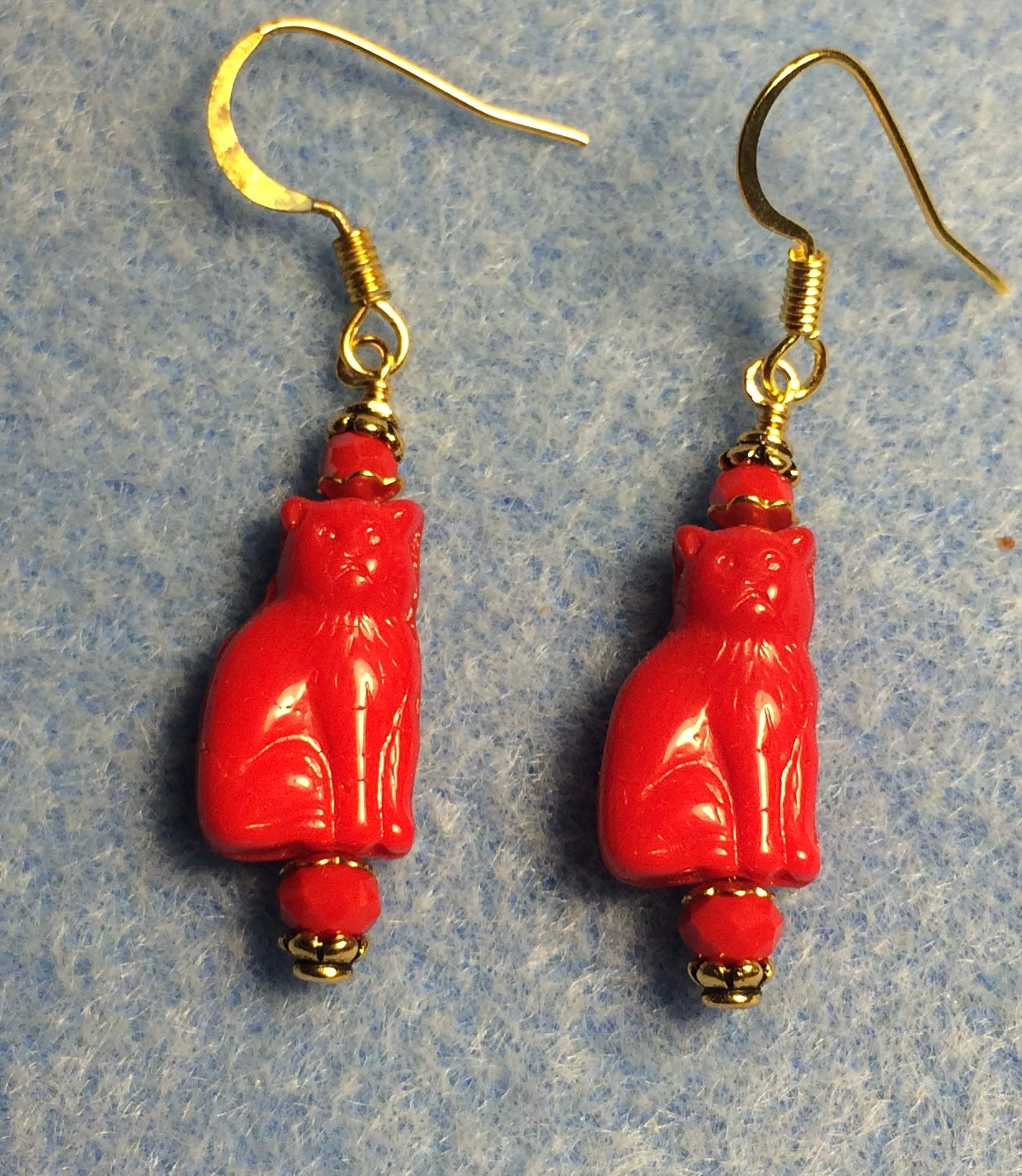 Small opaque red Czech glass cat bead earrings adorned with red Chinese crystal beads.