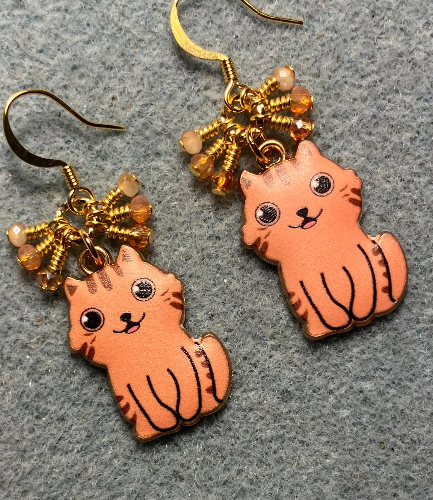 Orange and peach enamel cat charm earrings adorned with tiny dangling orange and peach Chinese crystal beads.