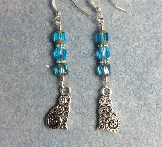 Silver swirly tailed cat charm earrings adorned with turquoise Czech glass beads