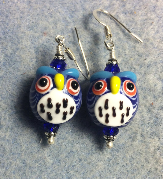 Dark blue and white lamp work spotted owl bead earrings adorned with dark blue Chinese crystal beads.