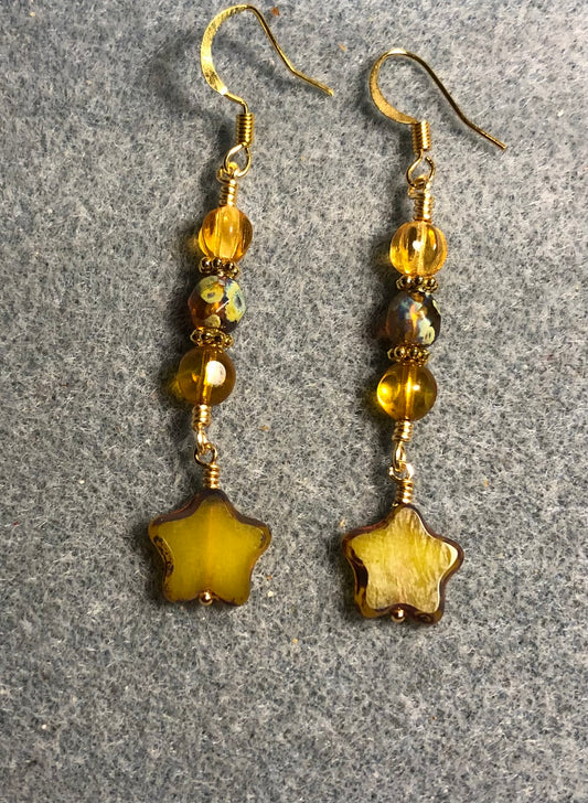 Small opaque yellow amber Czech glass star bead earrings adorned with yellow amber Czech glass beads.