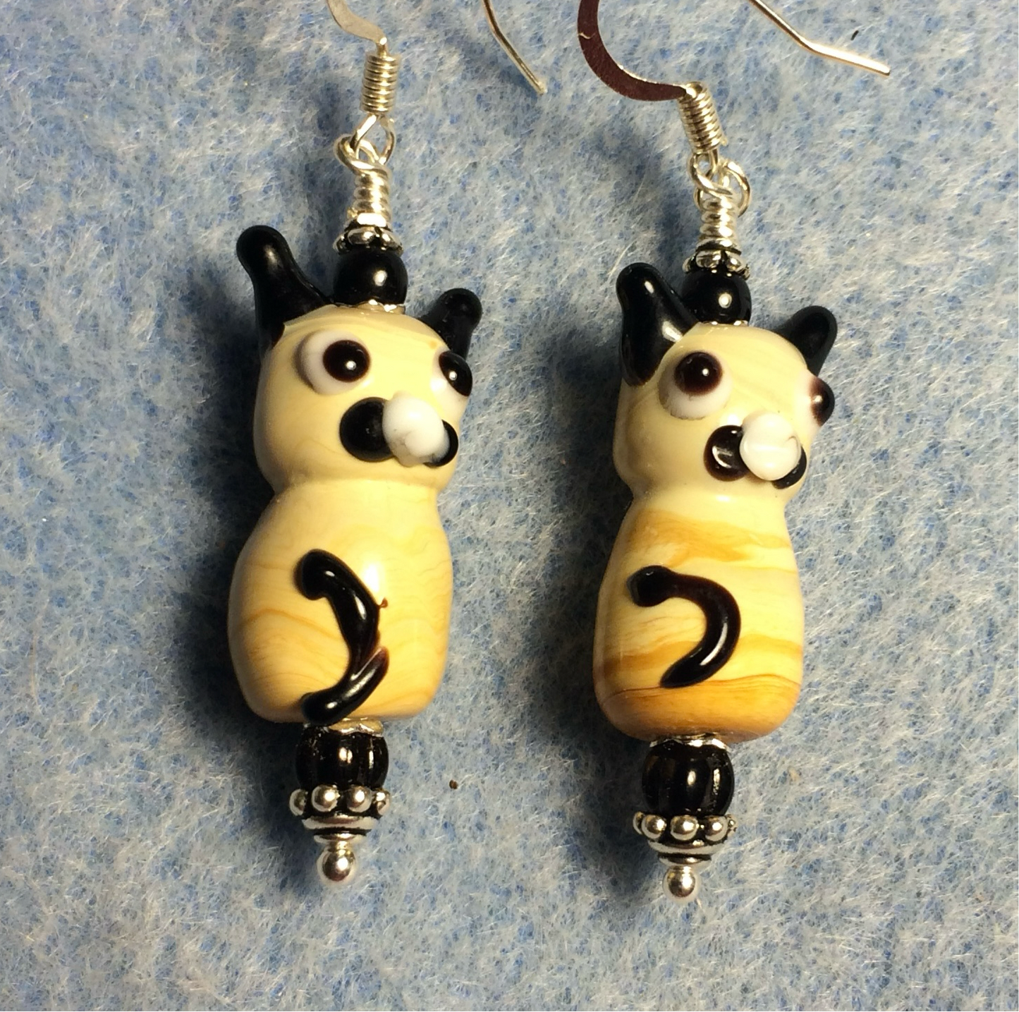 Tan and black lamp work cat bead earrings adorned with black Czech glass beads.