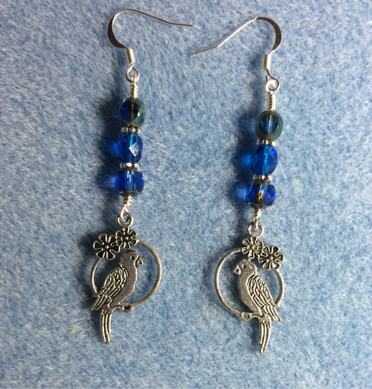 Silver parrot charm earrings adorned with blue Czech glass beads