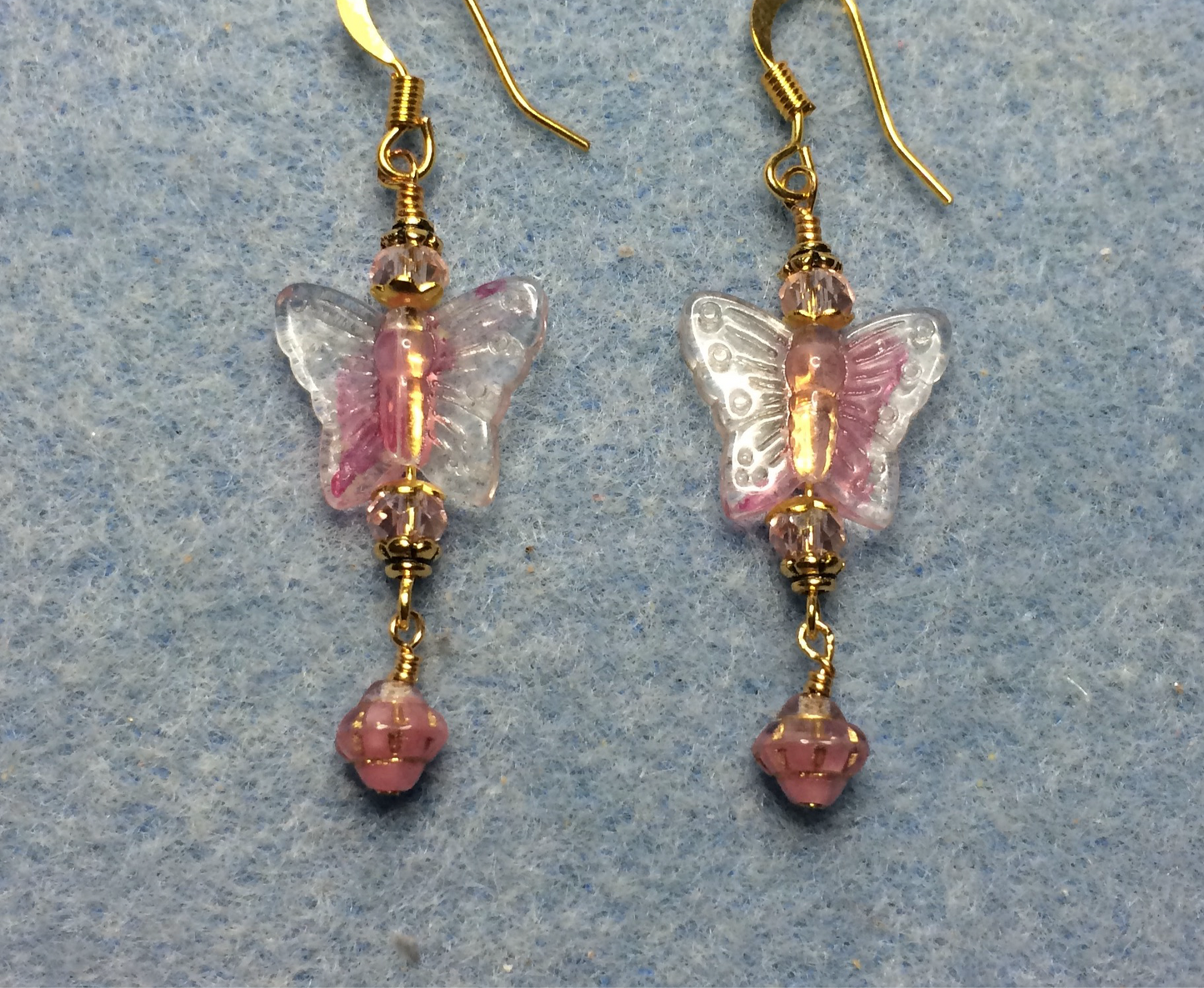 Pink glass butterfly bead earrings adorned with pink Chinese crystal beads and small pink Czech glass Saturn beads.