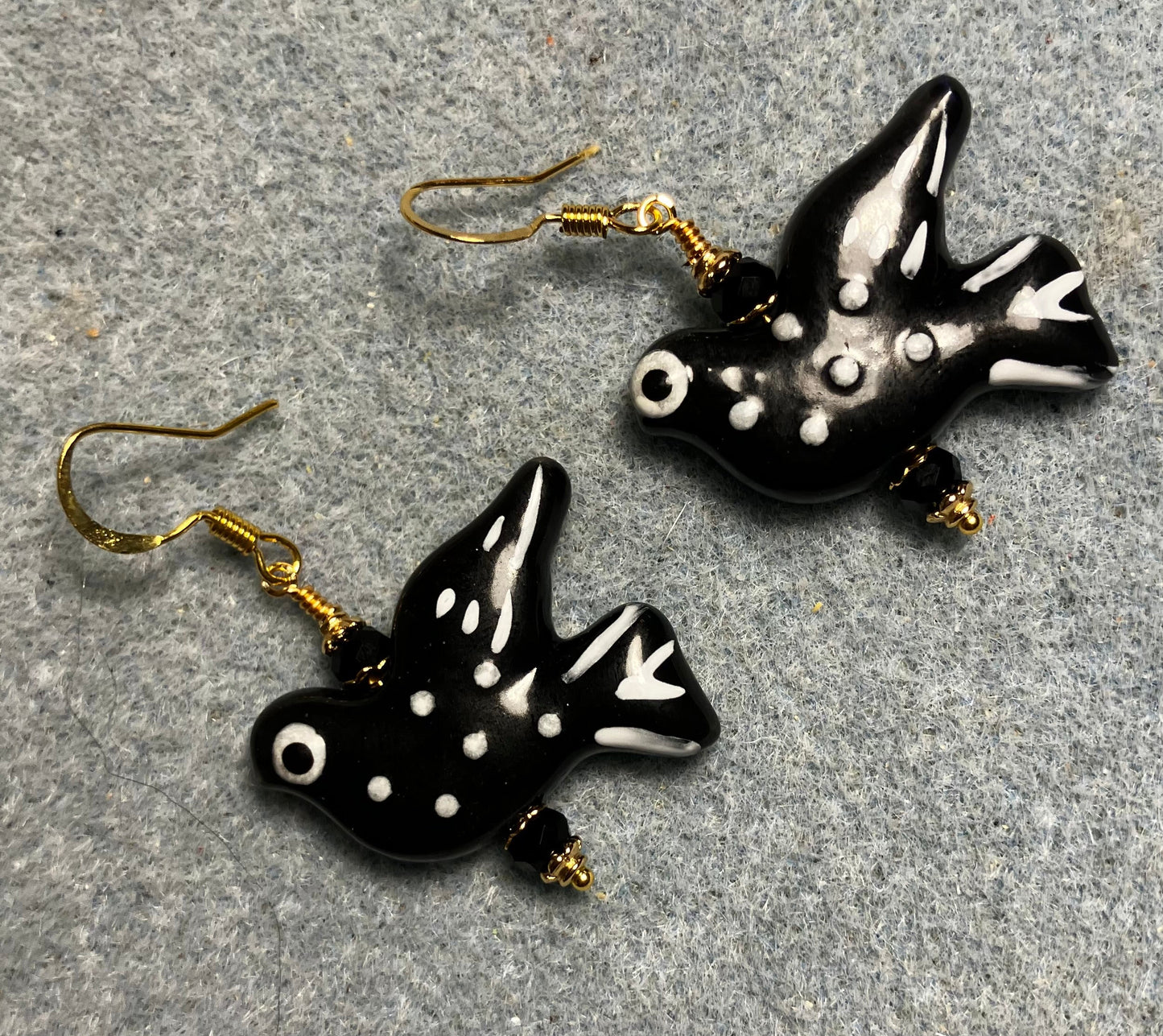 Large black and white ceramic spotted dove bead earrings adorned with black Chinese crystal beads.