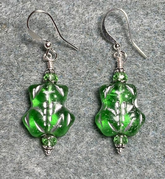 Translucent green (with silver inlay) Czech glass frog bead earrings adorned with light green Chinese crystal beads.