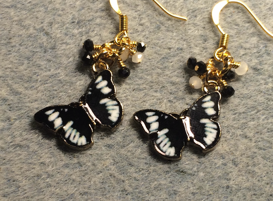 Black and white enamel butterfly charm earrings adorned with tiny dangling black and white Chinese crystal beads.