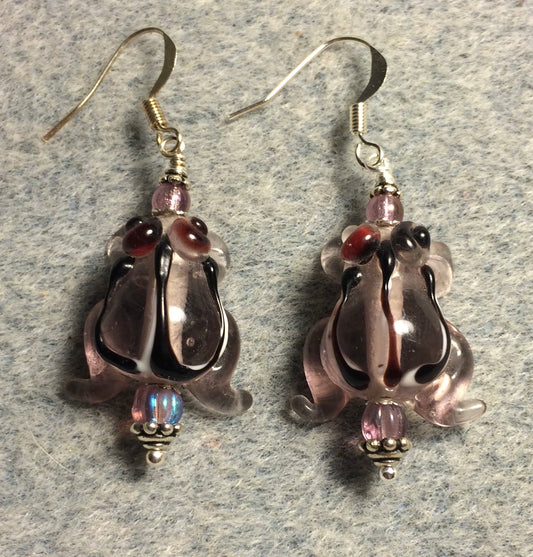 Translucent violet lamp work striped frog bead earrings adorned with violet Czech glass beads.