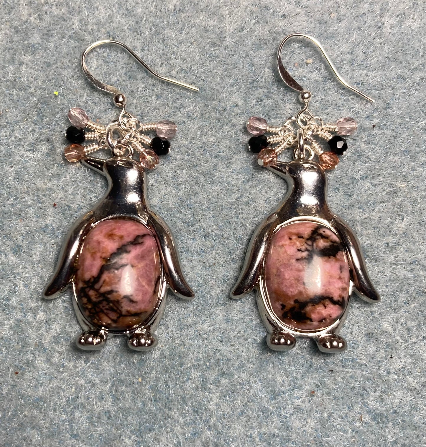 Large silver and pink rhodonite gemstone penguin charm earrings adorned with small dangling rose and black Czech glass beads.