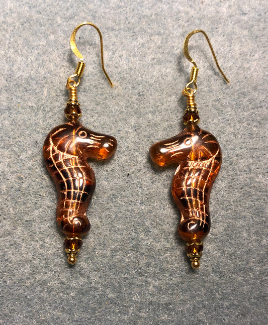 Dark amber (with gold inlay) Czech glass seahorse bead earrings adorned with dark amber Chinese crystal beads.