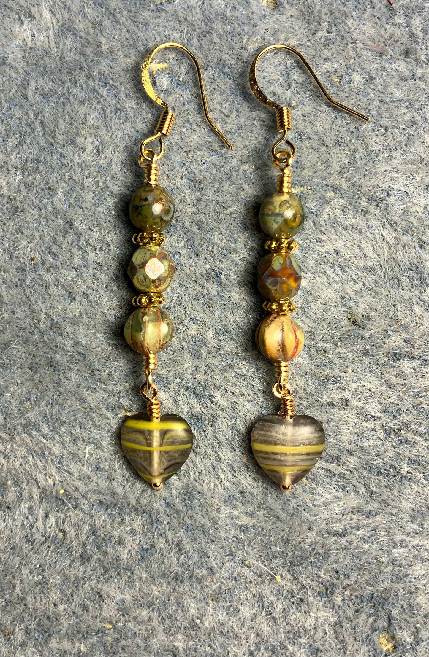 Small opaque green striped Czech glass heart bead earrings adorned with opaque green Picasso Czech glass beads.