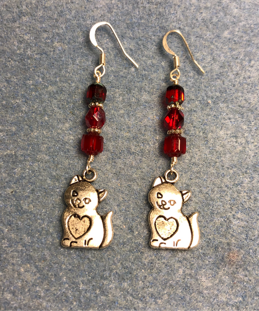 Silver cat charm earrings adorned with red Czech glass beads