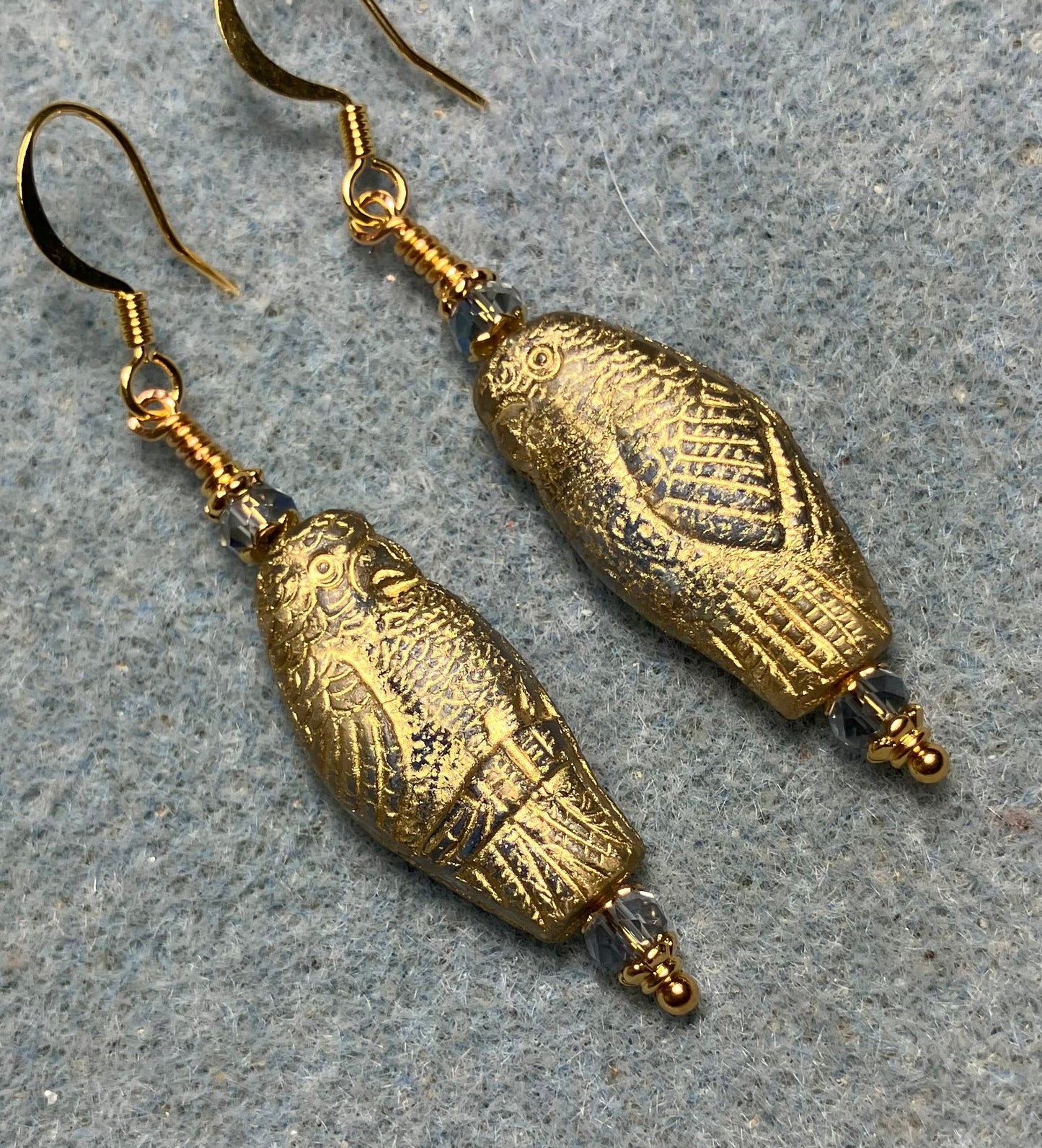 Large light blue (with gold wash) Czech glass parrot bead earrings adorned with light blue Chinese crystal beads.