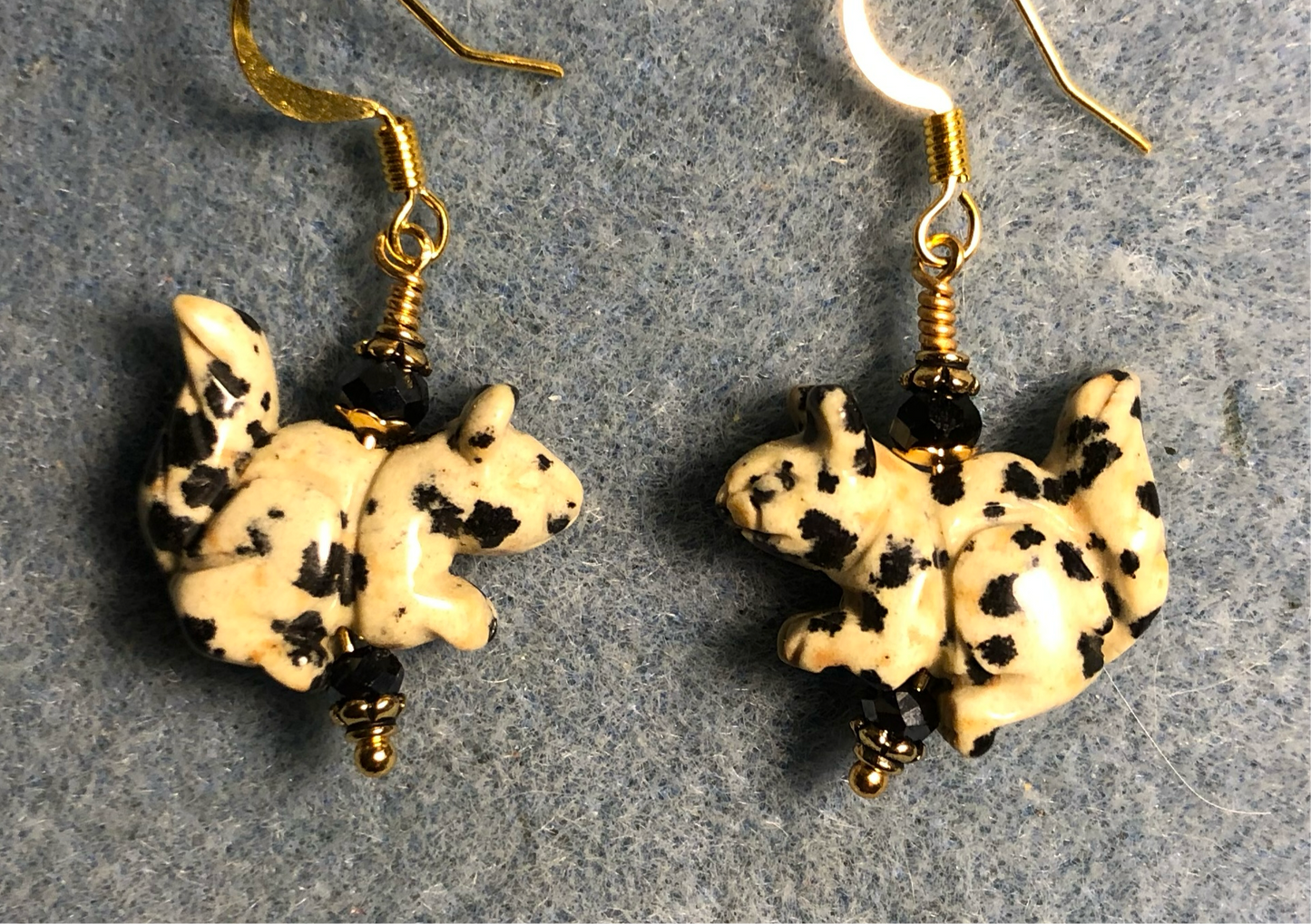 Dalmatian jasper gemstone squirrel bead earrings adorned with black Chinese crystal beads.