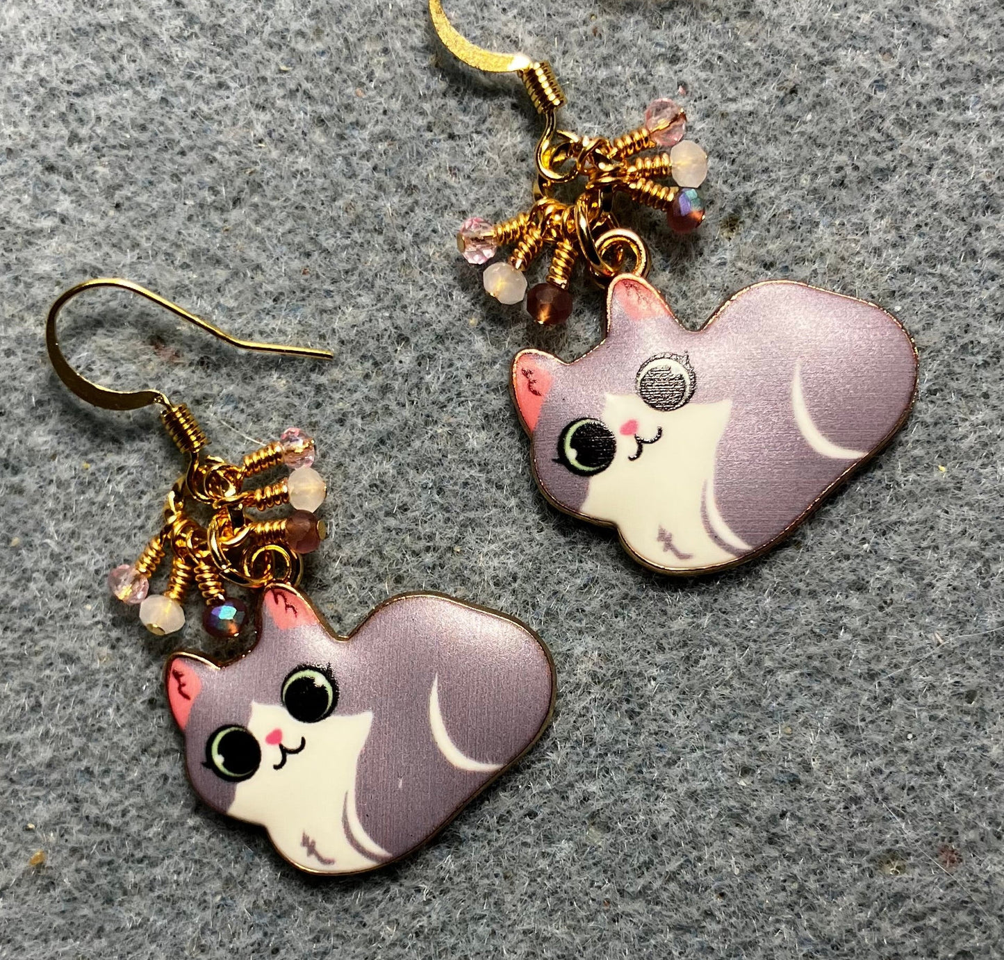 Violet, white, and pink enamel cat charm earrings adorned with tiny dangling violet, white, and pink Chinese crystal beads.