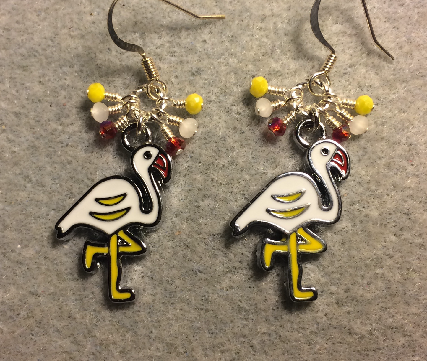 White and yellow enamel flamingo charm earrings adorned with tiny dangling yellow, white, and red Chinese crystal beads.