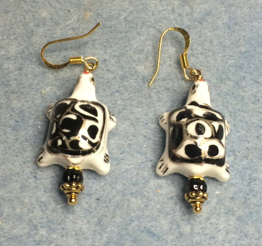 Black and white ceramic spotted turtle bead earrings adorned with black Czech glass beads.