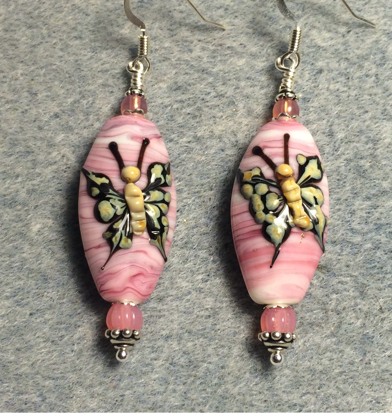 Pink and tan lamp work butterfly bead earrings adorned with pink Czech glass beads.