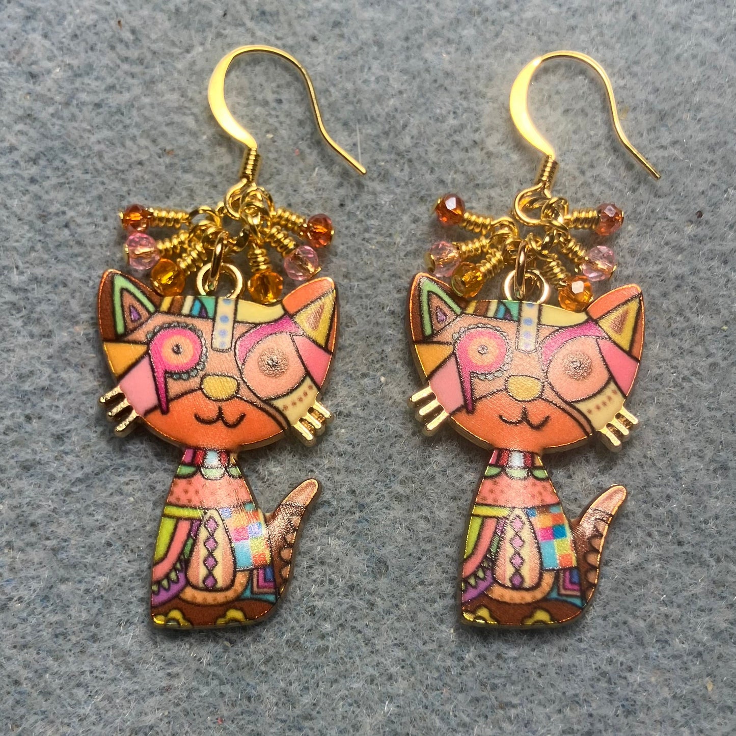 Orange and pink enamel cat charm earrings adorned with tiny dangling orange and pink Chinese crystal beads.