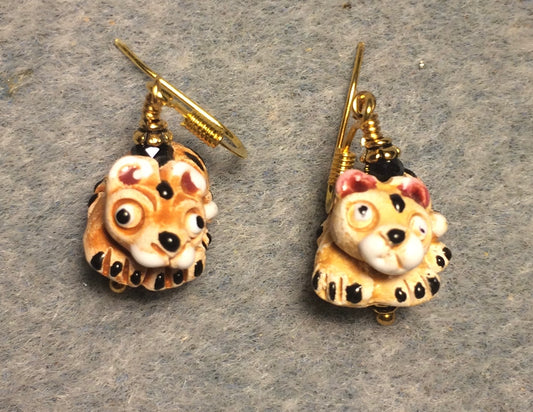 Small tan, black, and white ceramic tiger bead earrings adorned with black Chinese crystal beads.