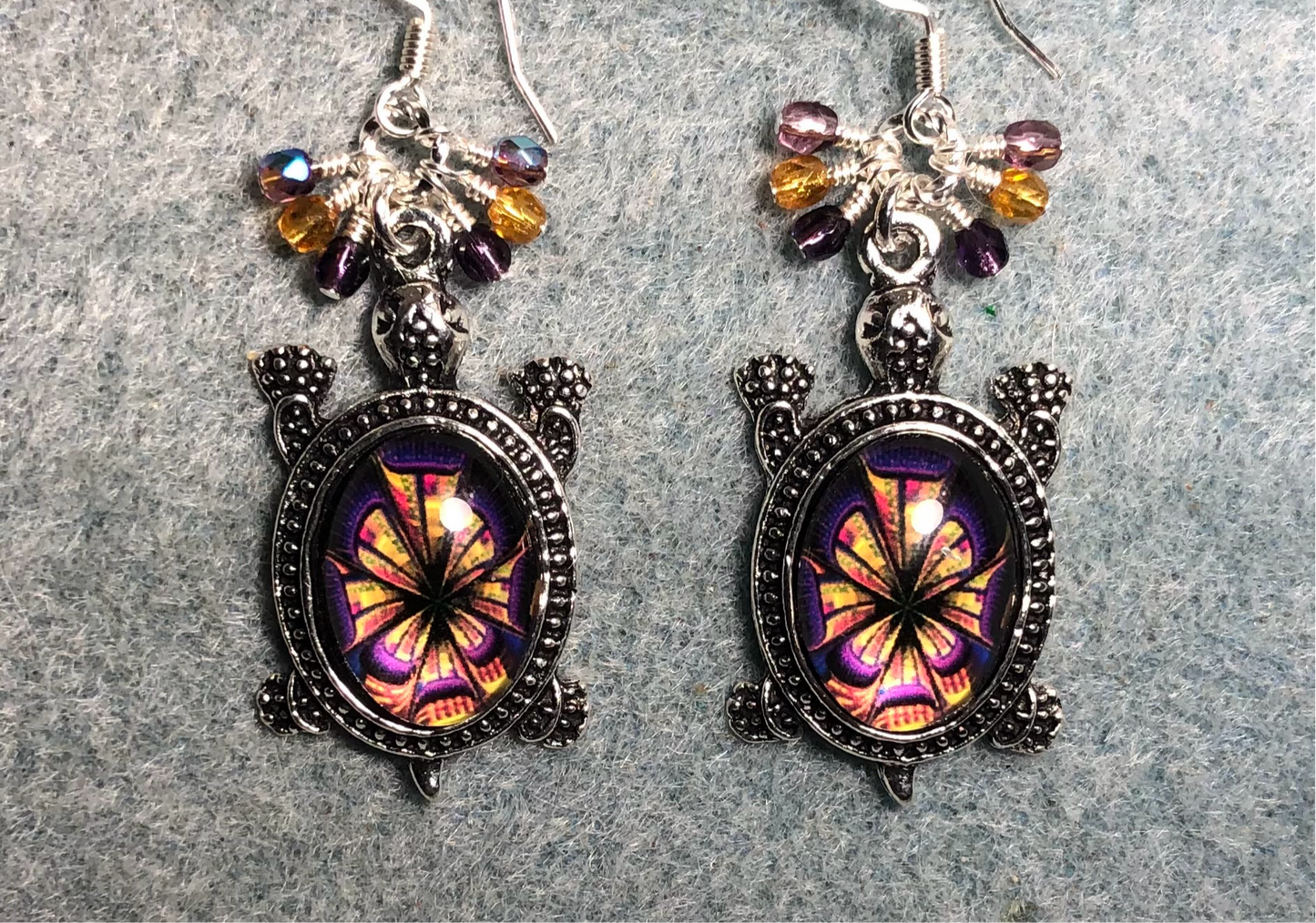 Large silver and purple and amber glass stone turtle charm earrings adorned with small dangling purple and amber Czech glass beads.