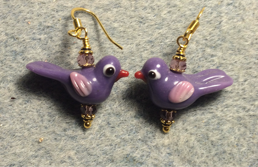 Opaque violet and pink lamp work songbird bead earrings adorned with violet Chinese crystal beads.