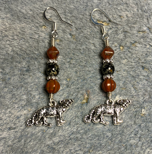 Silver leopard charm earrings adorned with orange and black Czech glass beads