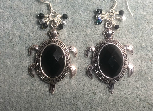 Large silver and black rhinestone turtle charm earrings adorned with small dangling black and silver Czech glass beads.