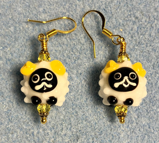 Small white, black, and yellow lamp work sheep bead earrings adorned with yellow Chinese crystal beads.