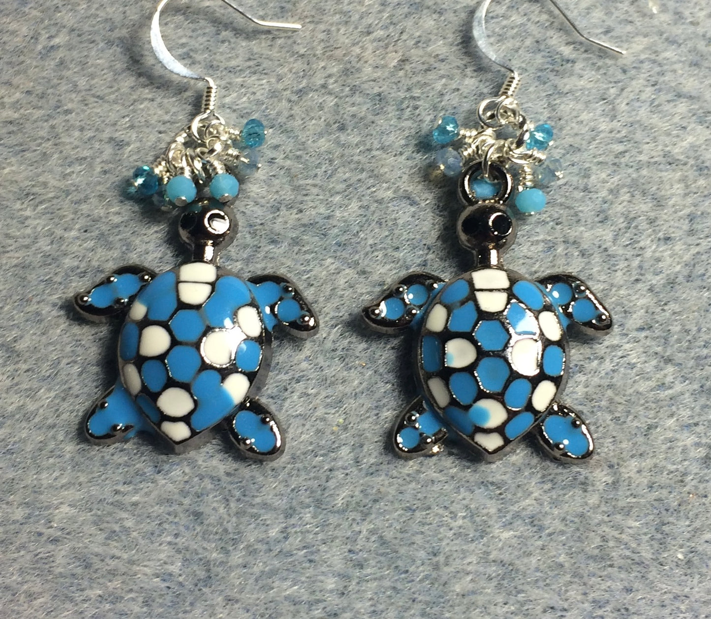 Large turquoise and white enamel turtle charm earrings adorned with small dangling turquoise Chinese crystal beads.