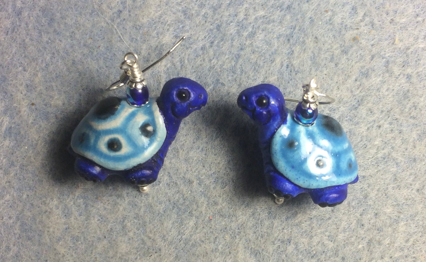 Large dark blue and light blue ceramic turtle bead earrings adorned with dark blue Czech glass beads.