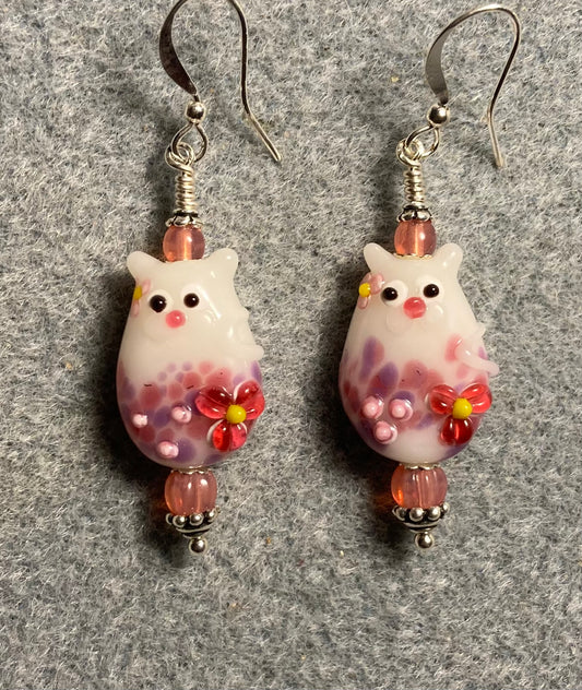 Pink lamp work cat bead earrings adorned with pink Czech glass beads.