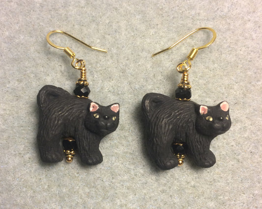 Black ceramic spooky cat bead earrings adorned with black Chinese crystal beads.