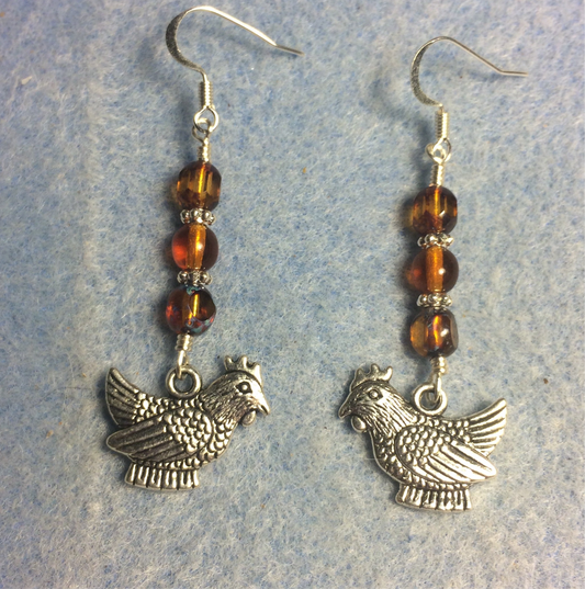 Silver chicken charm earrings adorned with amber Czech glass beads