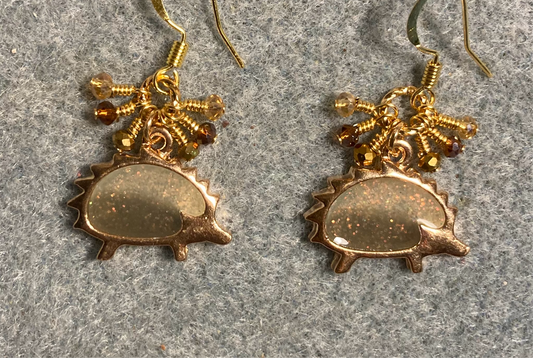 Gold and sparkly brown resin hedgehog charm earrings adorned with tiny dangling brown, gold, and clear Chinese crystal beads.