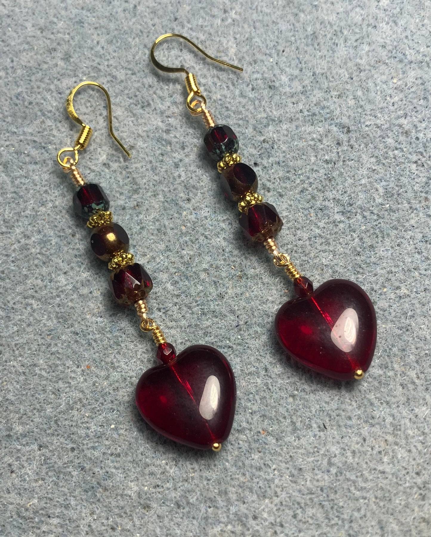 Ruby red Czech glass heart bead earrings adorned with ruby red Czech glass beads.