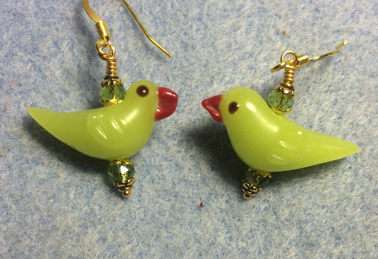 Opaque olive green lamp work songbird bead earrings adorned with olive green Chinese crystal beads.