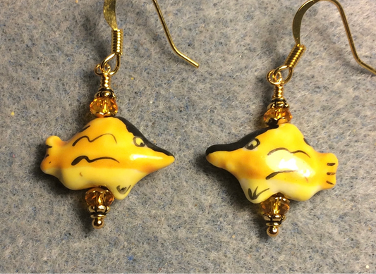 Small yellow and black ceramic swordfish bead earrings adorned with tangerine Chinese crystal beads.