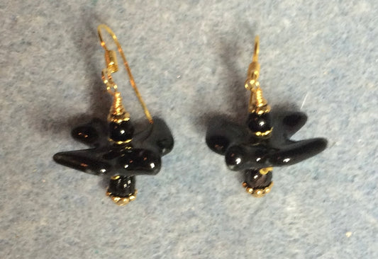 Black ceramic flying bird bead earrings adorned with black Czech glass beads.